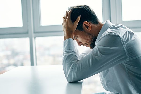 Person in distress at a desk.