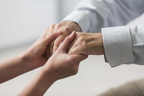 nurse-holding-senior-man-s-hands-sympathy nurse-holding-senior-man-s-hands-sympathy